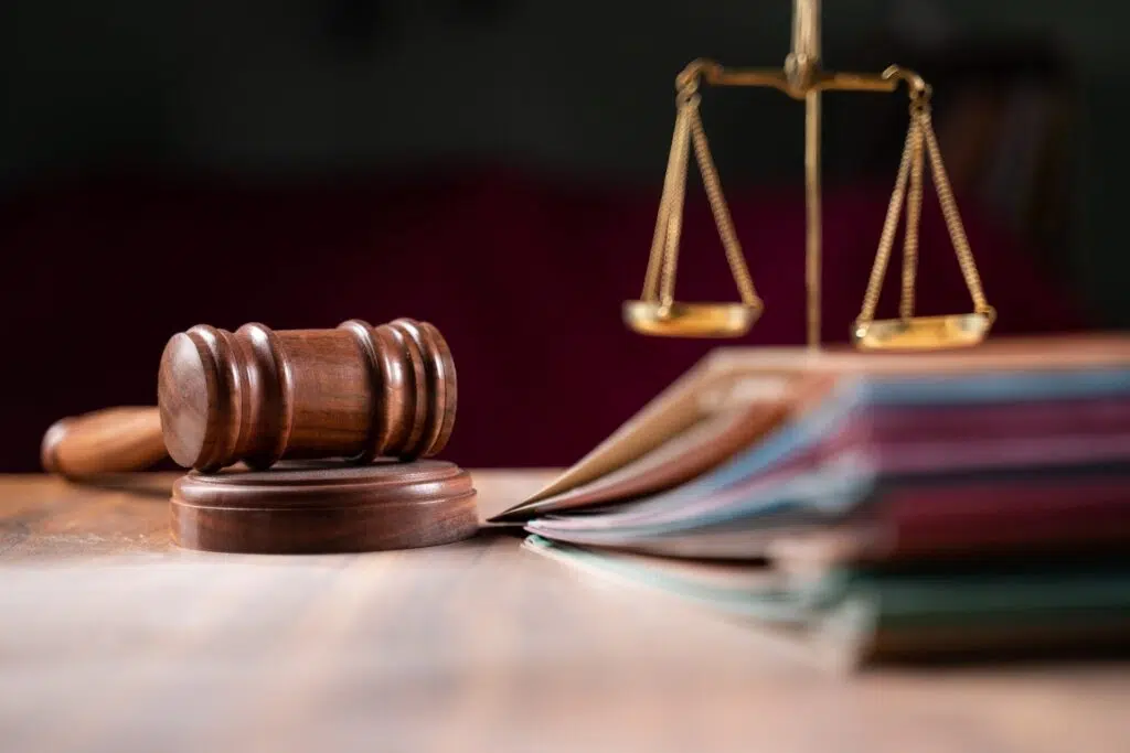 Ornate scales of justice on a wooden surface | Domestic Violence Lawyer | The Hemmat Law Group