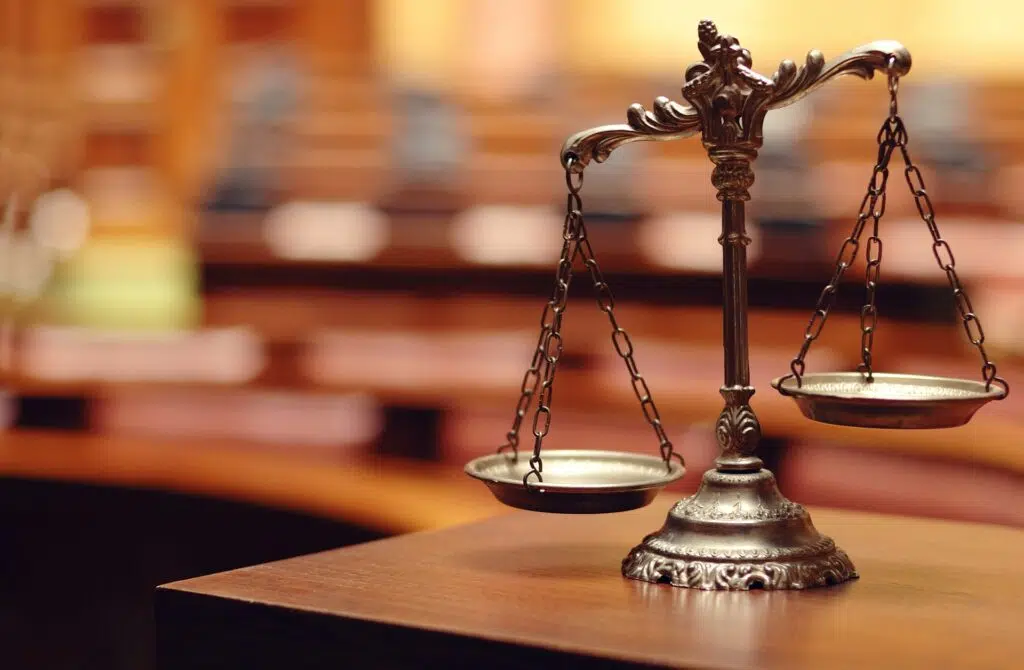 Ornate scales of justice on a wooden surface | Family Law Attorney | The Hemmat Law Group
