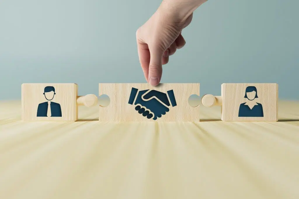 Puzzle piece with handshake between man and woman figures | divorce attorney | The Hemmat Law Group