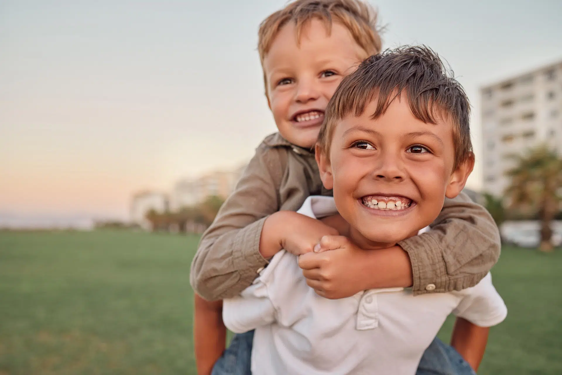 Two Smiling Young Boys Enjoying a Piggyback Ride | Family Law Attorney | The Hemmat Law Group