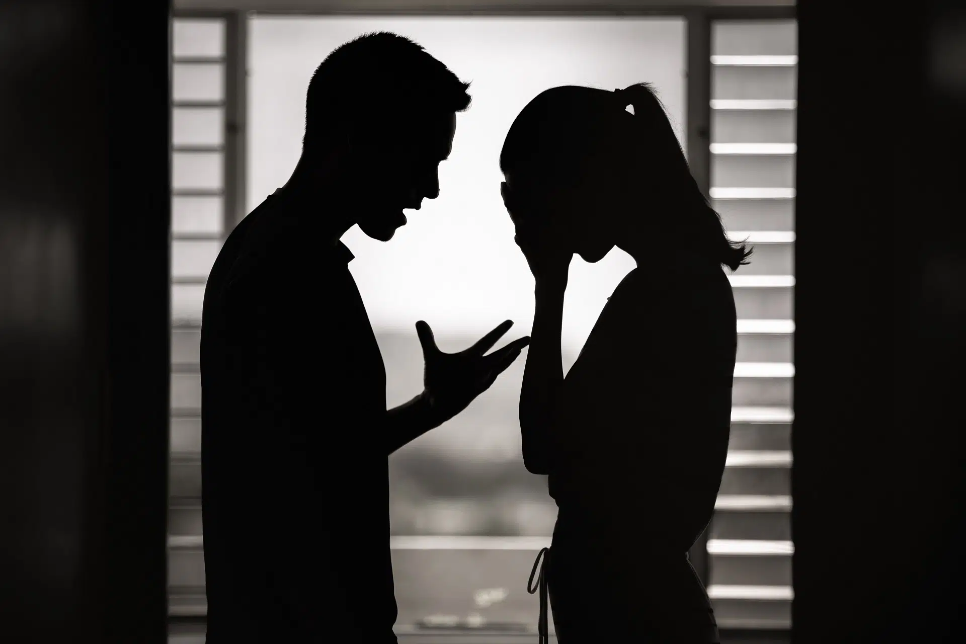 Silhouettes of Man and Woman in a Serious Conversation | Divorce Lawyer Seattle | The Hemmat Law Group