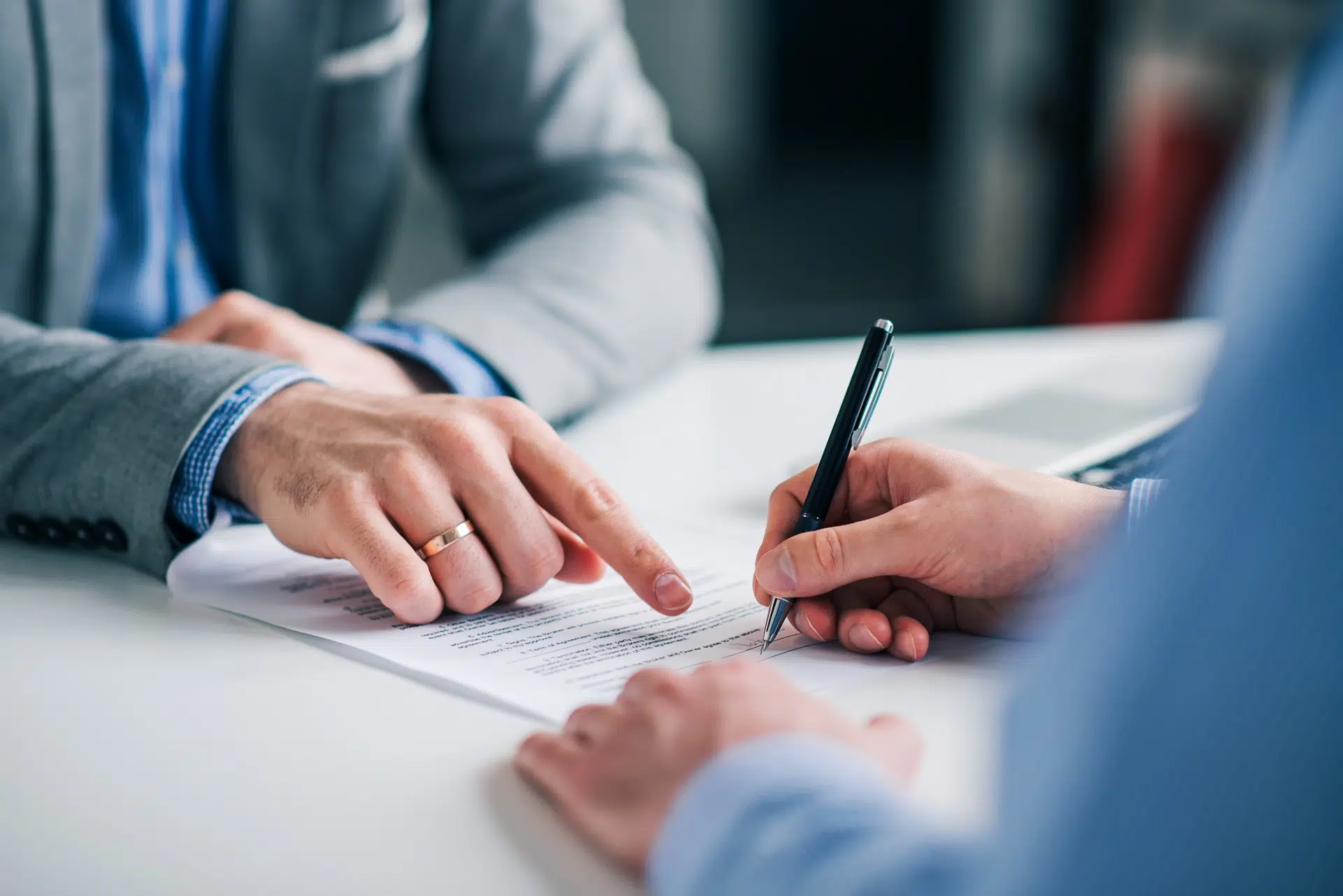Two People Reviewing and Signing a Document | Restraining Order Lawyer | The Hemmat Law Group