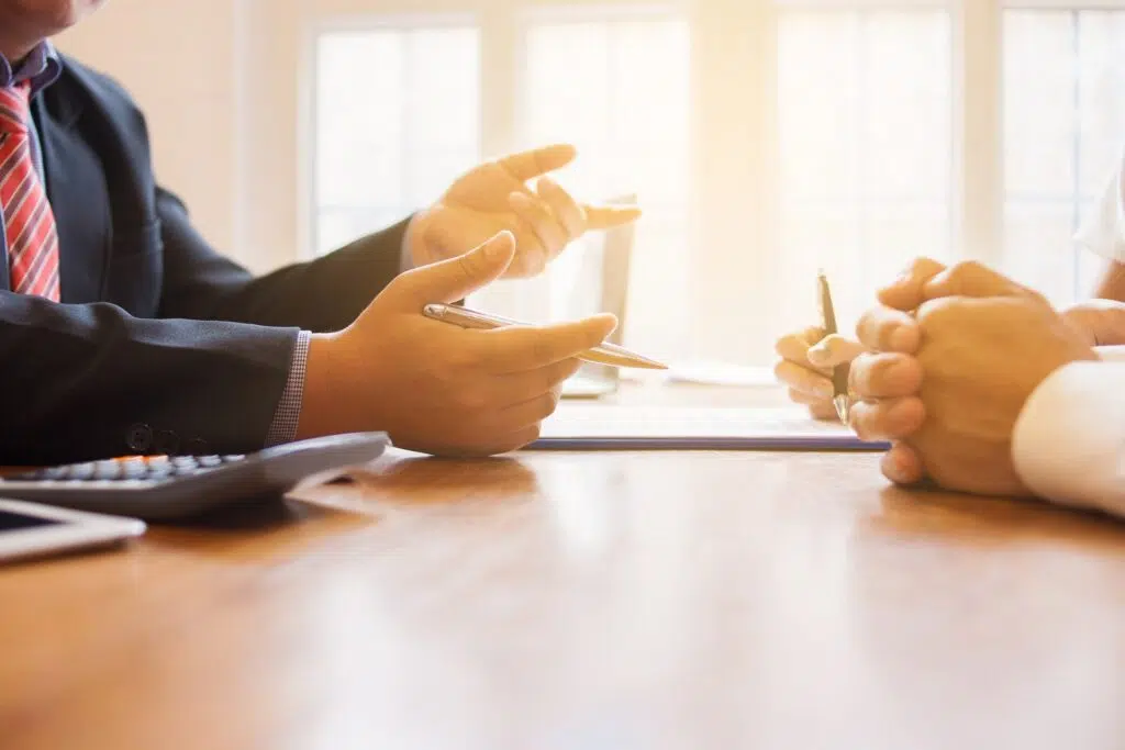 Three People in a Meeting Illuminated by Sunlight | Divorce Attorney Seattle | The Hemmat Law Group