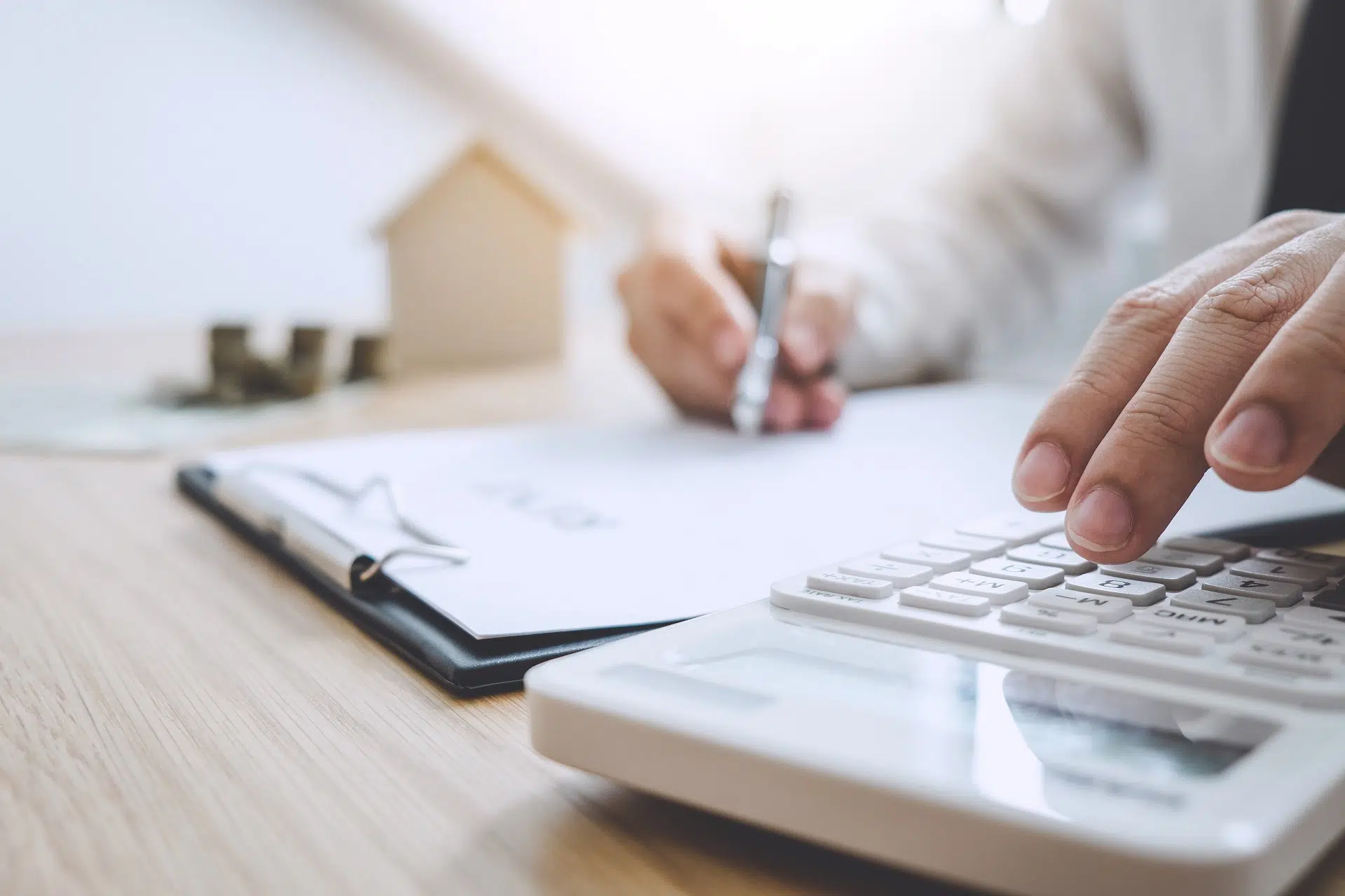 A Person Calculating Finances with a Calculator | Divorce Lawyer | The Hemmat Law Group
