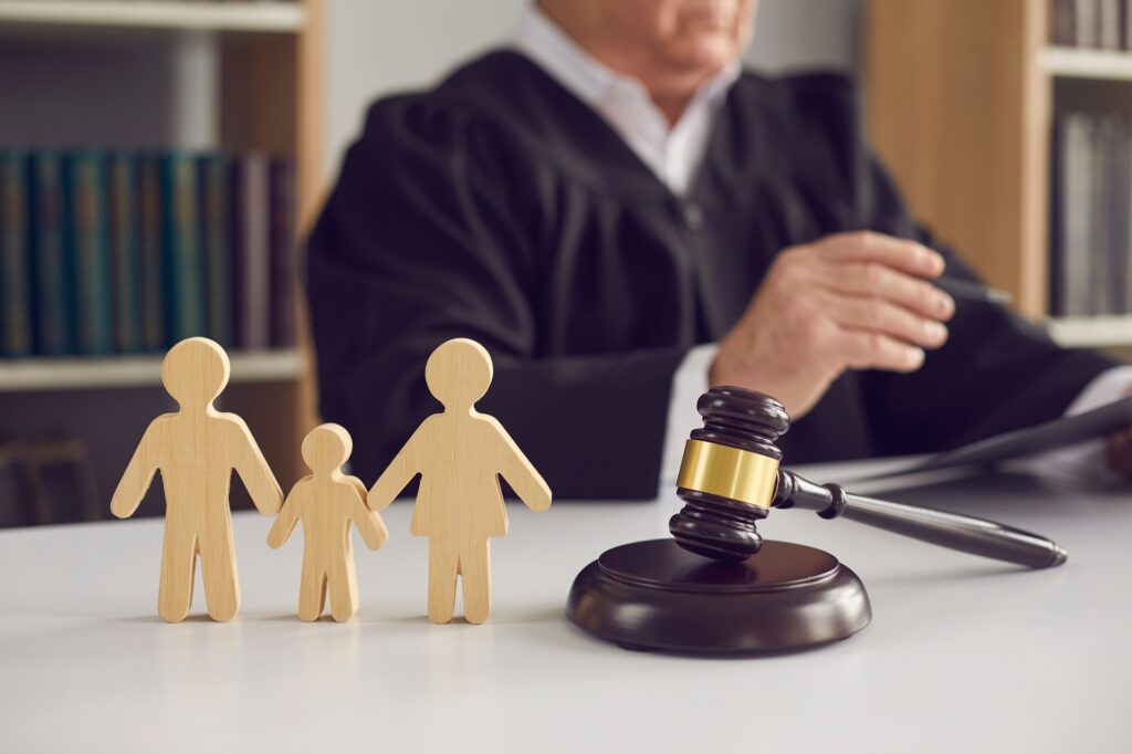 A Judge with a Family, Gavel and Wooden Figurines | Family Lawyer | Hemmat Law Group