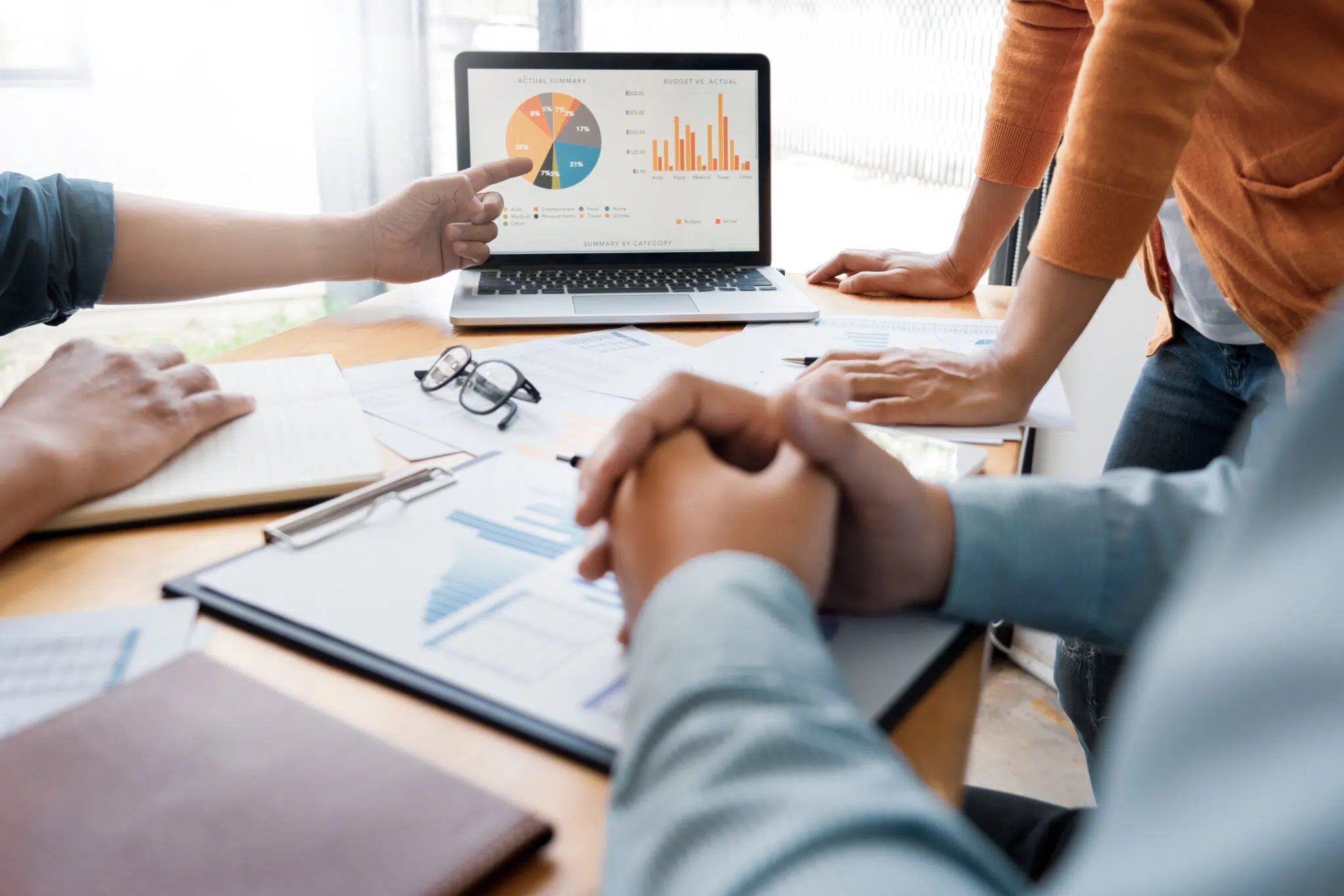 A team collaborates at a table | family law attorney | The Hemmat Law Group