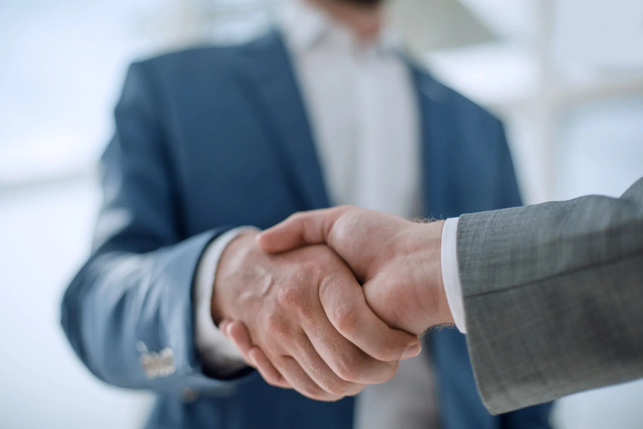 Close-up of a handshake between two people | domestic violence lawyer | The Hemmat Law Group