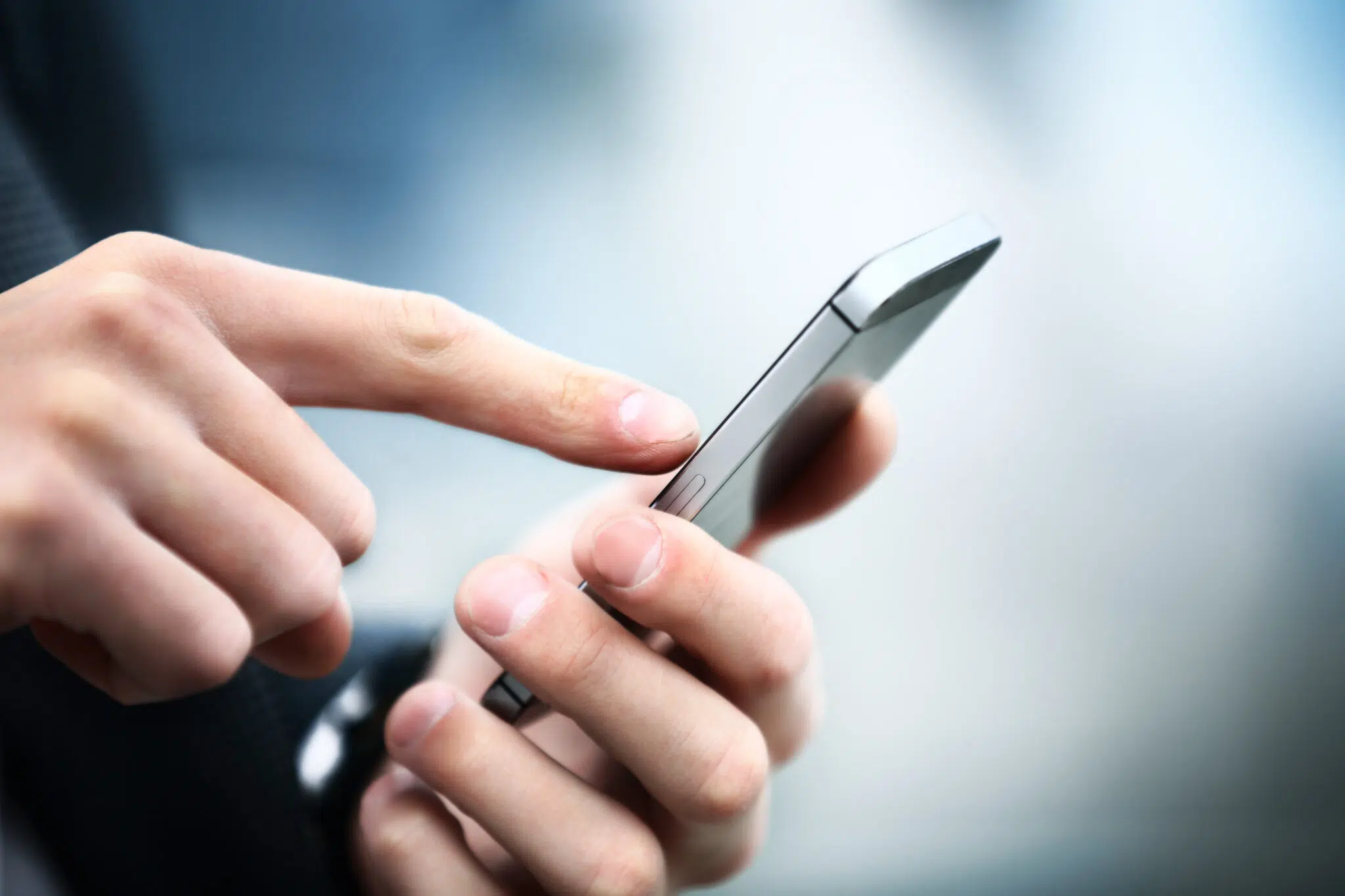 Man using a smartphone | family law attorney seattle | The Hemmat Law Group