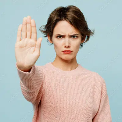 Angry woman with short brown hair holding her hand up | child custody lawyer | The Hemmat Law Group