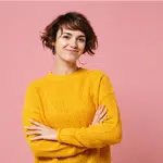Smiling woman with short brown hair wearing a yellow sweater | Family Lawyer | The Hemmat Law Group