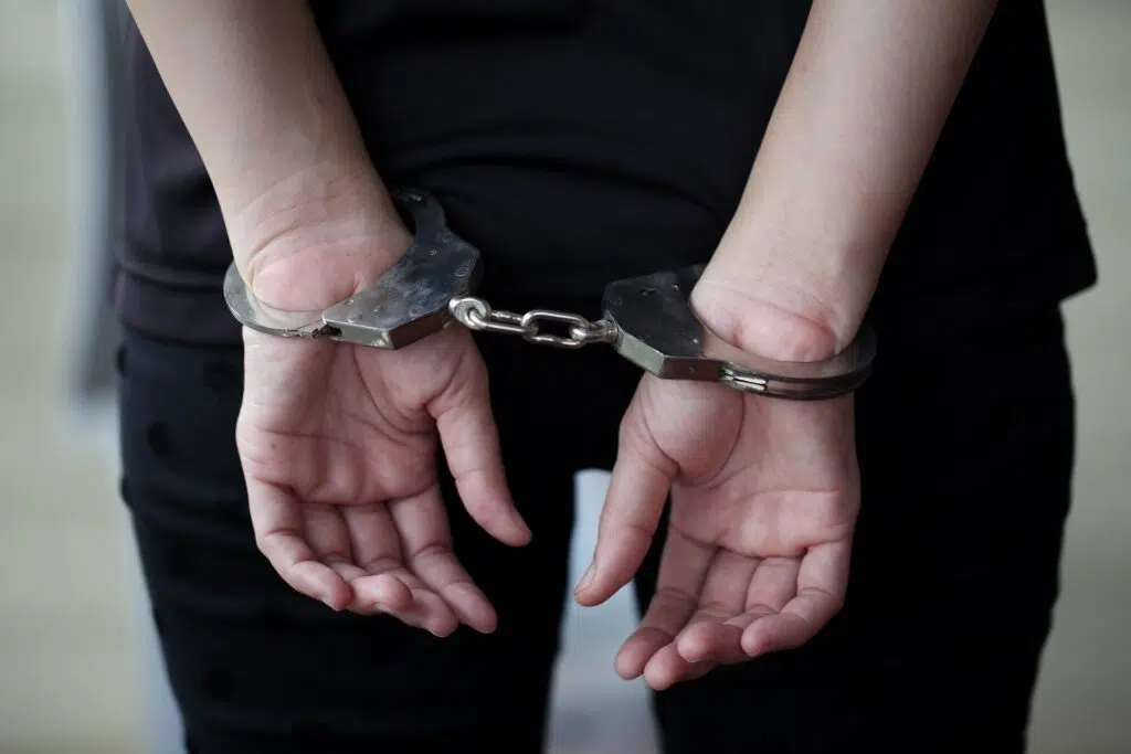 Hands behind in metal handcuffs | protection orders attorney | The Hemmat Law Group