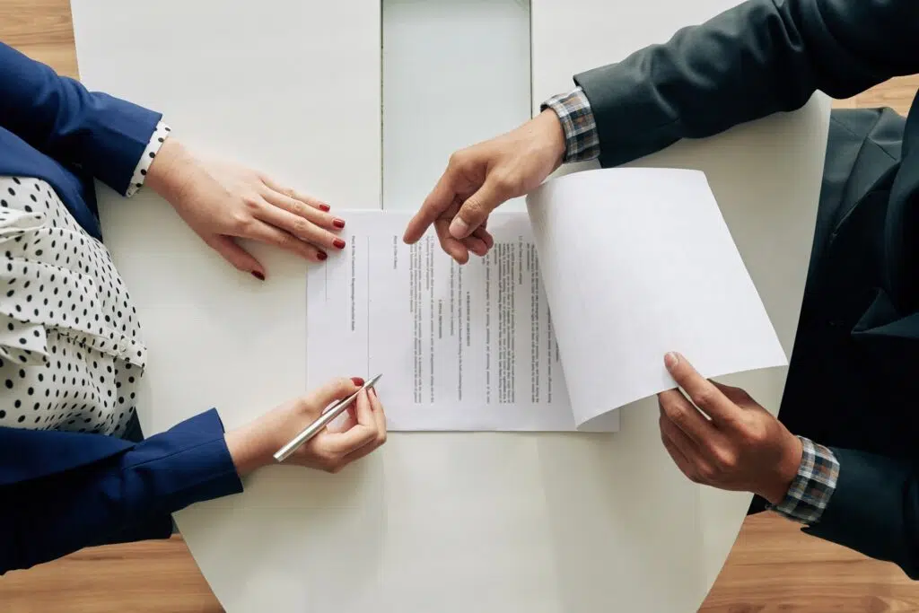People reviewing and signing documents | Family Law Reforms | The Hemmat Law Group
