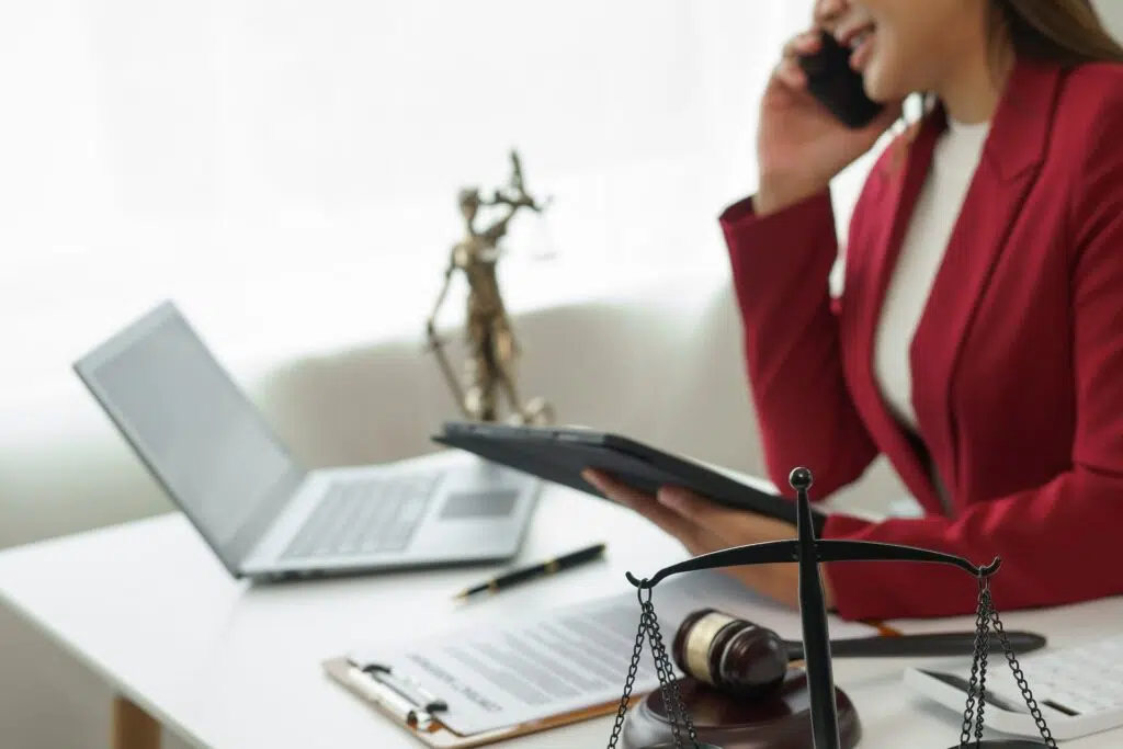 Lawyer on phone with legal items | Divorce Lawyer | The Hemmat Law Group