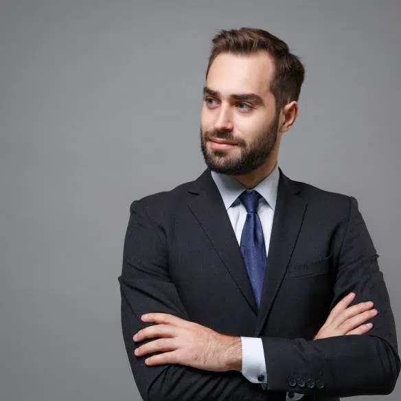 A confident man in a formal black suit and blue tie | Family Law Attorney | The Hemmat Law Group