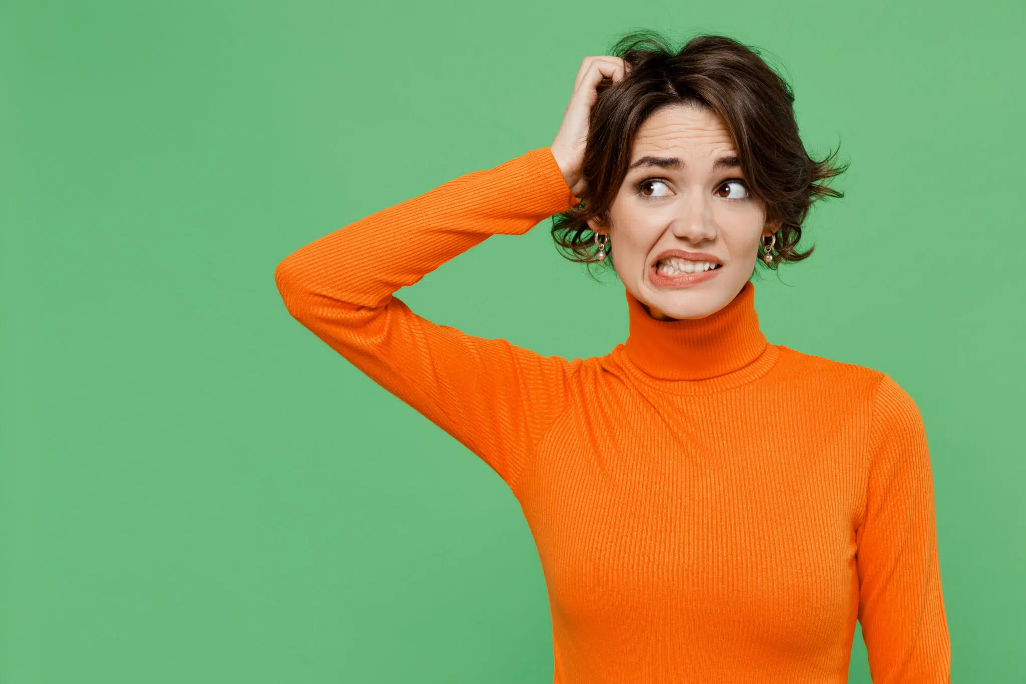 Woman in orange turtleneck scratching her head | child support lawyer | The Hemmat Law Group