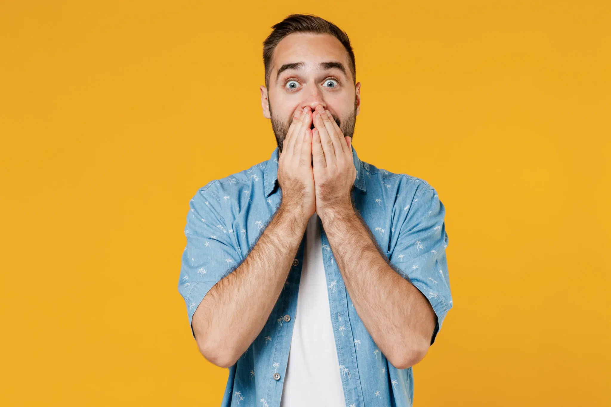 Shocked man covering his mouth with both hands | divorce lawyer | The Hemmat Law Group