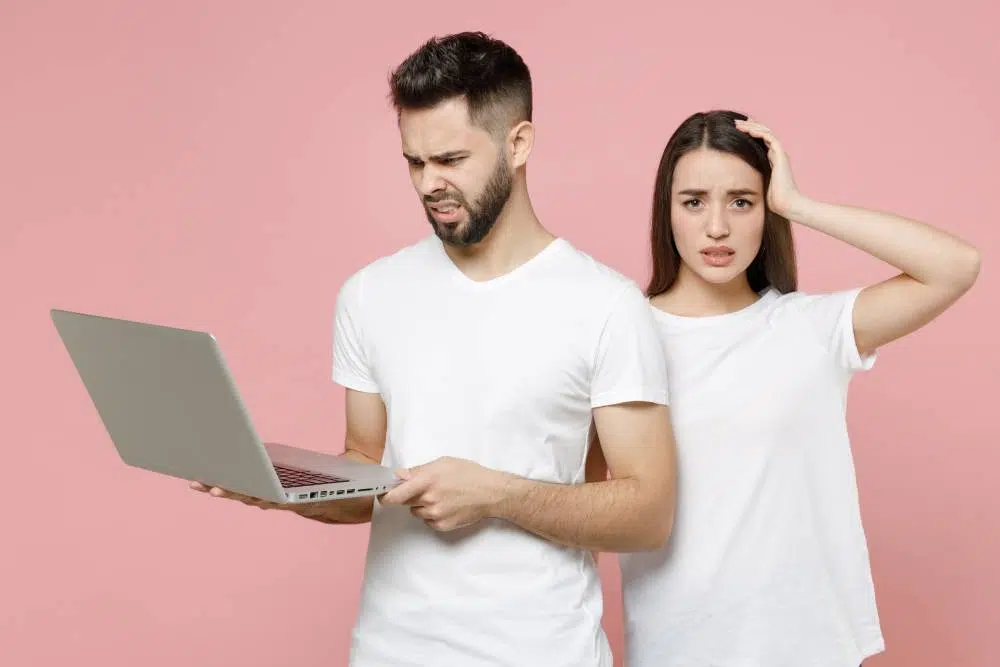 Man holding laptop and woman looking puzzled | Child Custody Lawyer | The Hemmat Law Group
