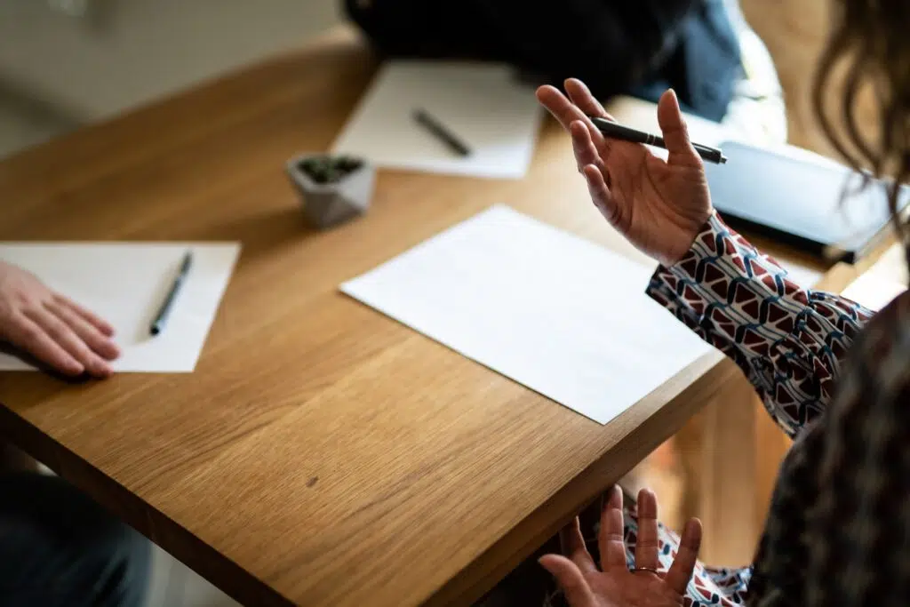 People sitting at a table with papers and pens | family lawyer seattle | The Hemmat Law Group