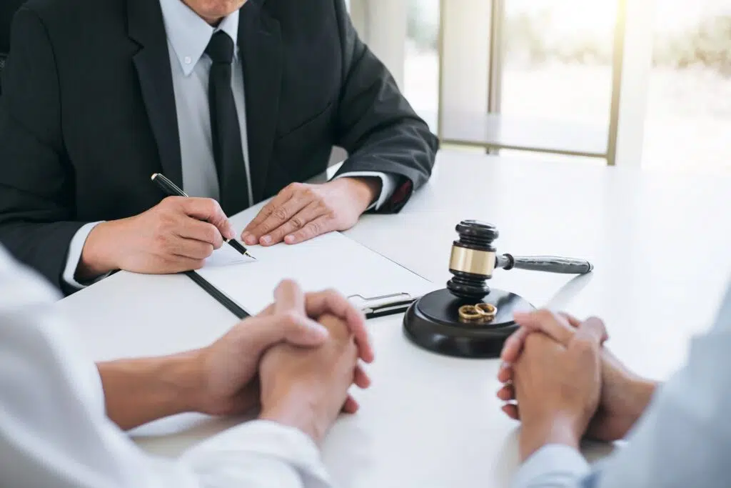 A lawyer in a suit writes on a notepad | Divorce Lawyer Seattle | The Hemmat Law Group