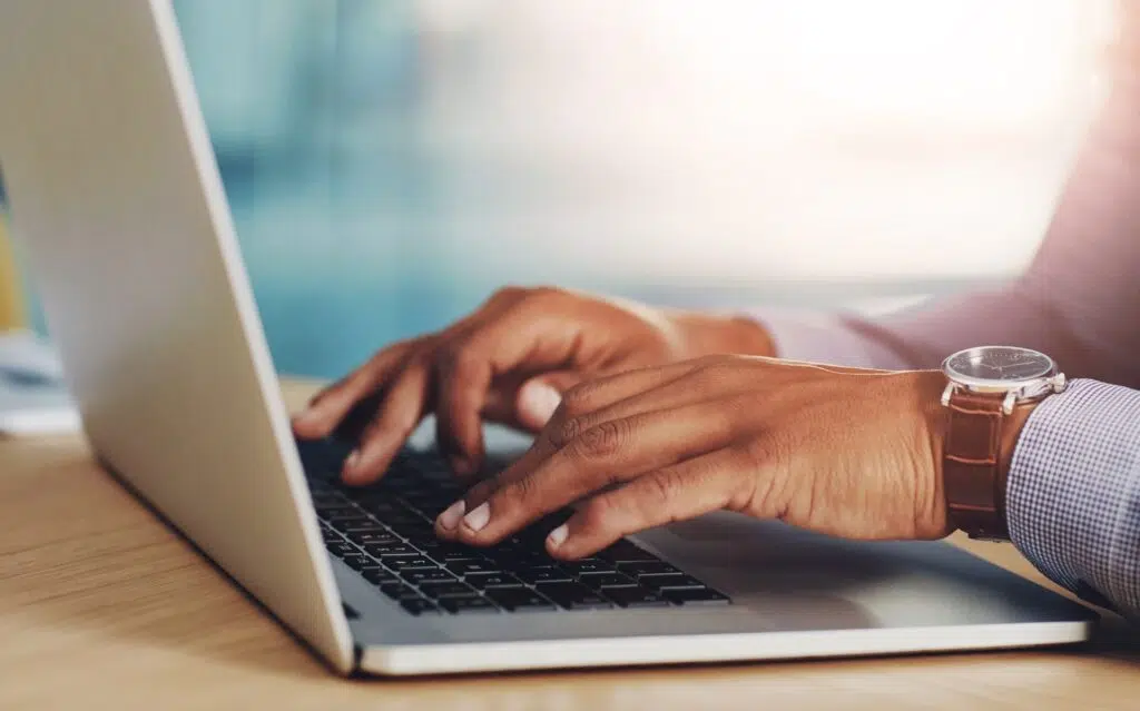 Close-up of hands typing on a laptop | Child Custody Lawyer | The Hemmat Law Group