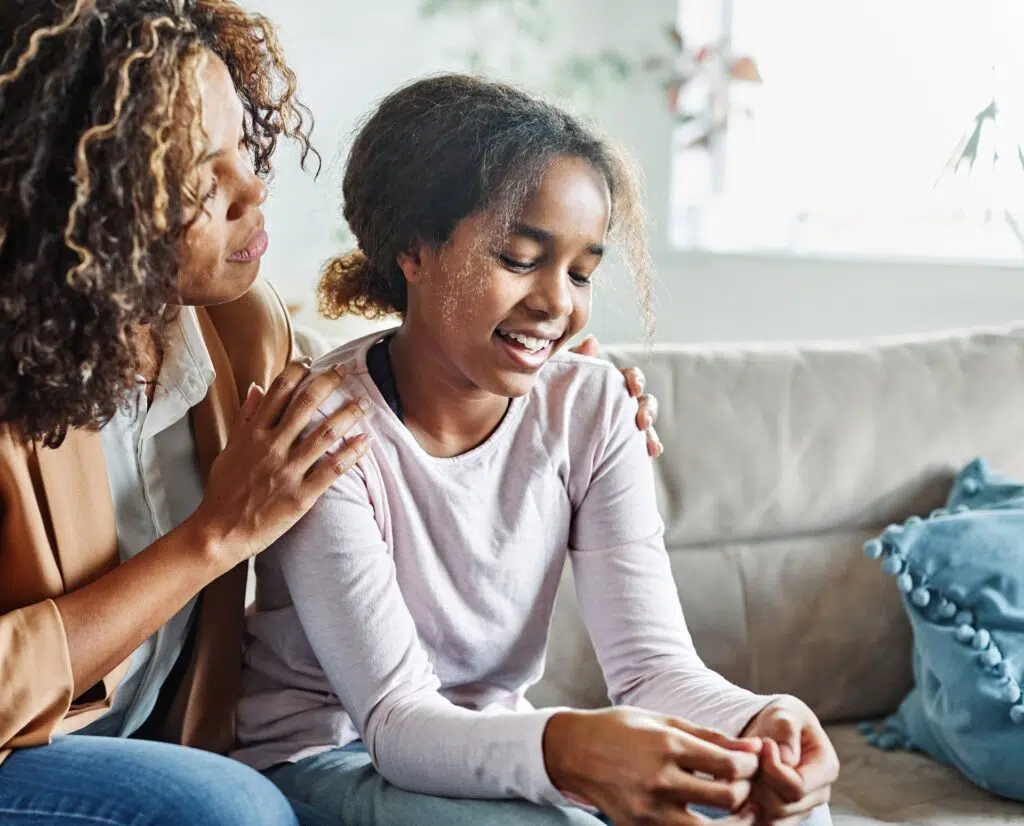 A woman with curly brown hair comforting a girl | Child Support Attorney | The Hemmat Law Group