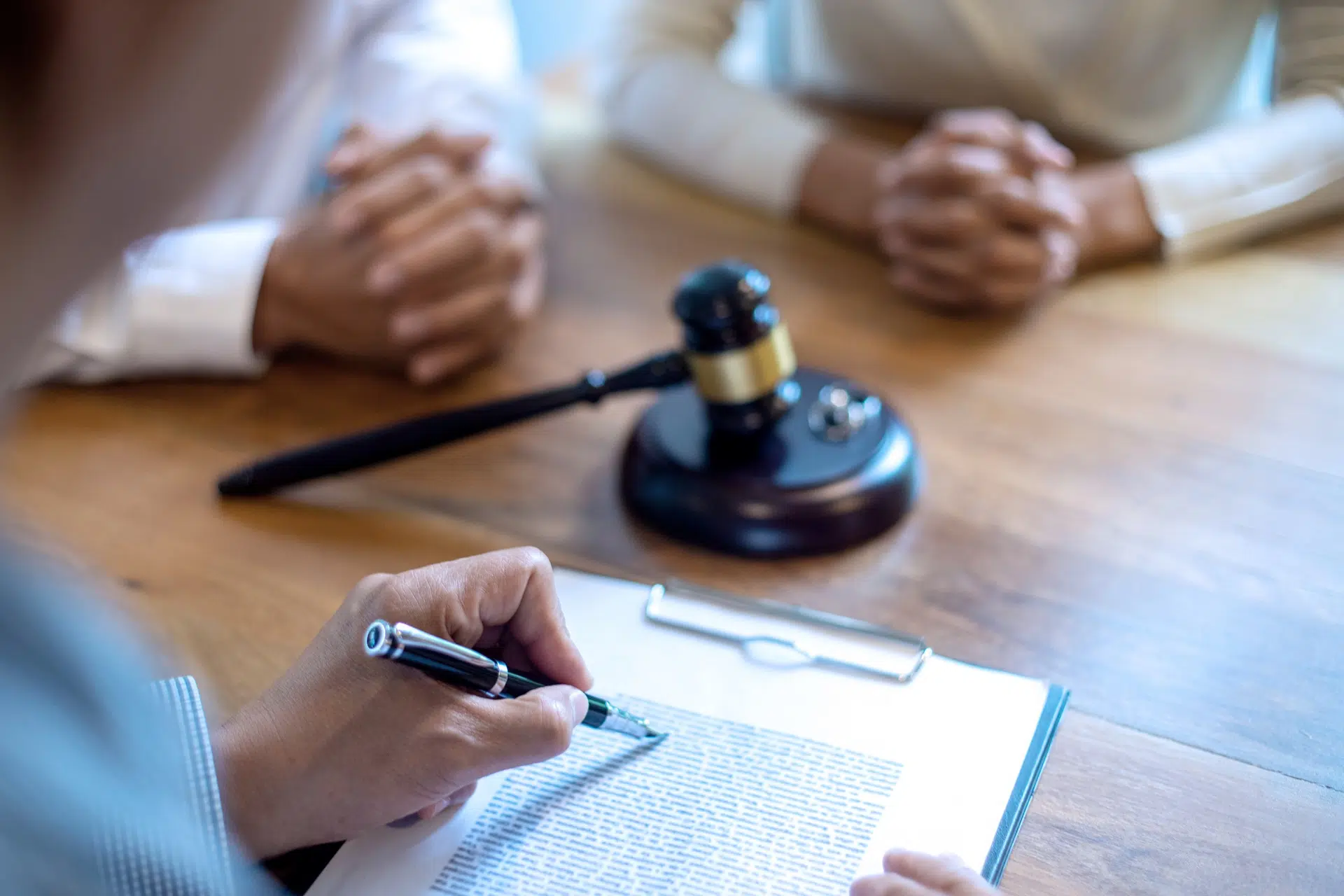 A person writes notes on a clipboard | divorce attorney seattle | The Hemmat Law Group
