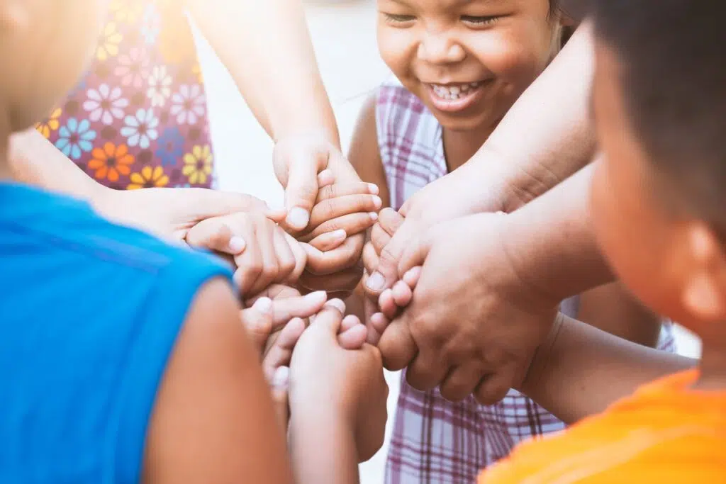 Group of children’s hands grasp each other tightly | Child Custody Lawyer  | The Hemmat Law Group