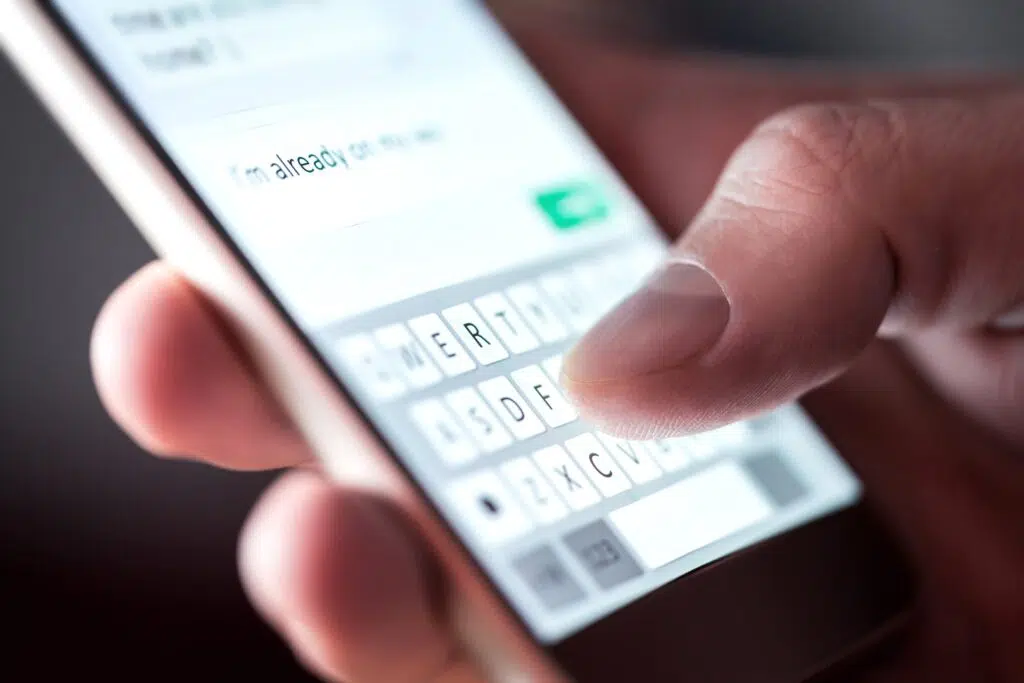 A close-up of a hand holding a smartphone | Divorce Lawyer Seattle  | The Hemmat Law Group