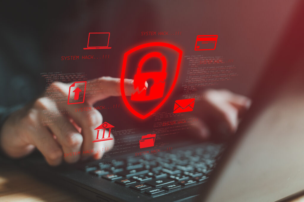 A person points at a floating graphic of a red lock symbol above a laptop.
