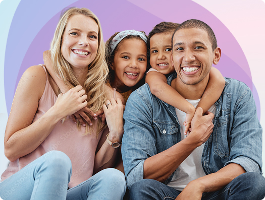 Smiling family of four posing together against pastel backdrop | Hemmat Law Group