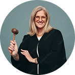 Female judge smiling while holding a wooden courtroom gavel | Hemmat Law Group