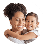 Smiling mother carrying her young daughter in her arms | Hemmat Law Group