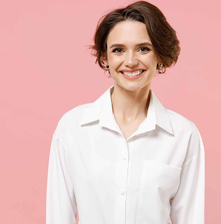 Smiling woman in white blouse against a pink backdrop | Hemmat Law Group