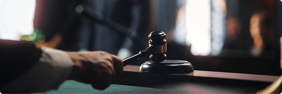 Judge's wooden gavel resting on bench inside a courtroom | Hemmat Law Group