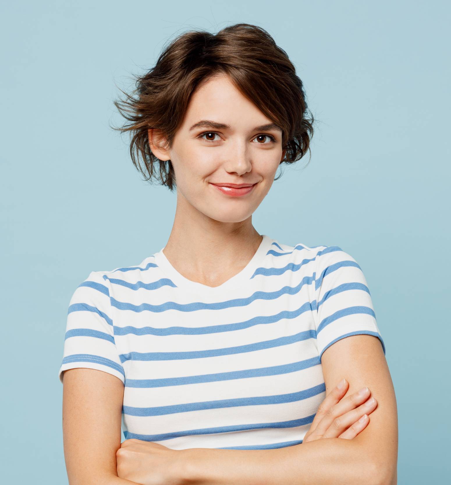 Smiling woman in striped shirt against a light blue background | Hemmat Law Group