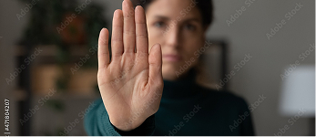 Woman holding up one hand in a protective stop gesture | Hemmat Law Group