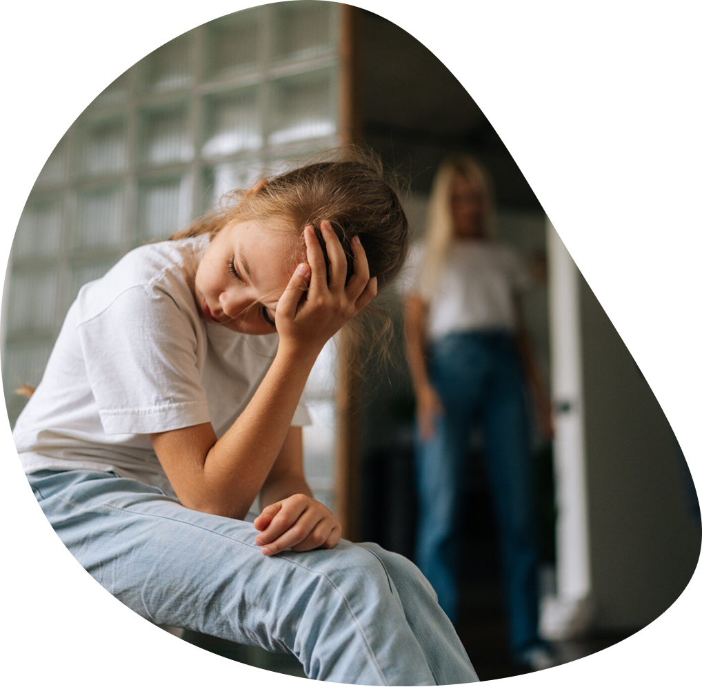 Upset girl sitting, woman standing in doorway | Hemmat Law Group