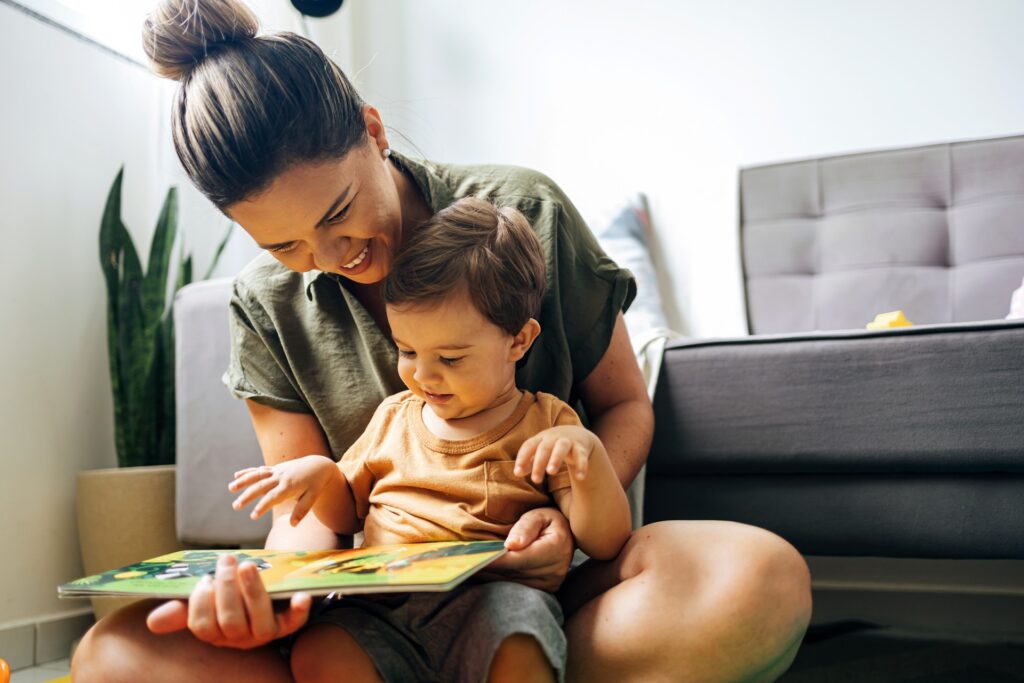 Mother reading a picture book with her child at home | Hemmat Law Group