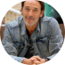 Man in denim jacket leaning forward during a conversation | Hemmat Law Group