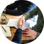 Hands joined together during a collaborative professional meeting | Hemmat Law Group