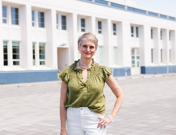 Professional woman standing outdoors near a modern office building | Hemmat Law Group