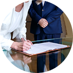 Legal professionals reviewing paperwork across a desk | Hemmat Law Group