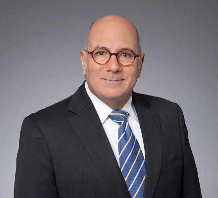 Professional headshot of a man in a dark suit and tie | Hemmat Law Group