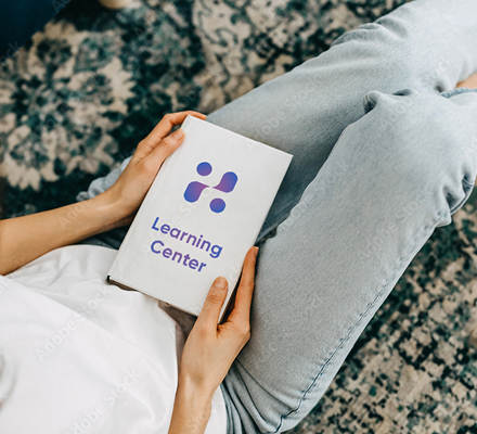 Person holding a Learning Center booklet while seated | Hemmat Law Group