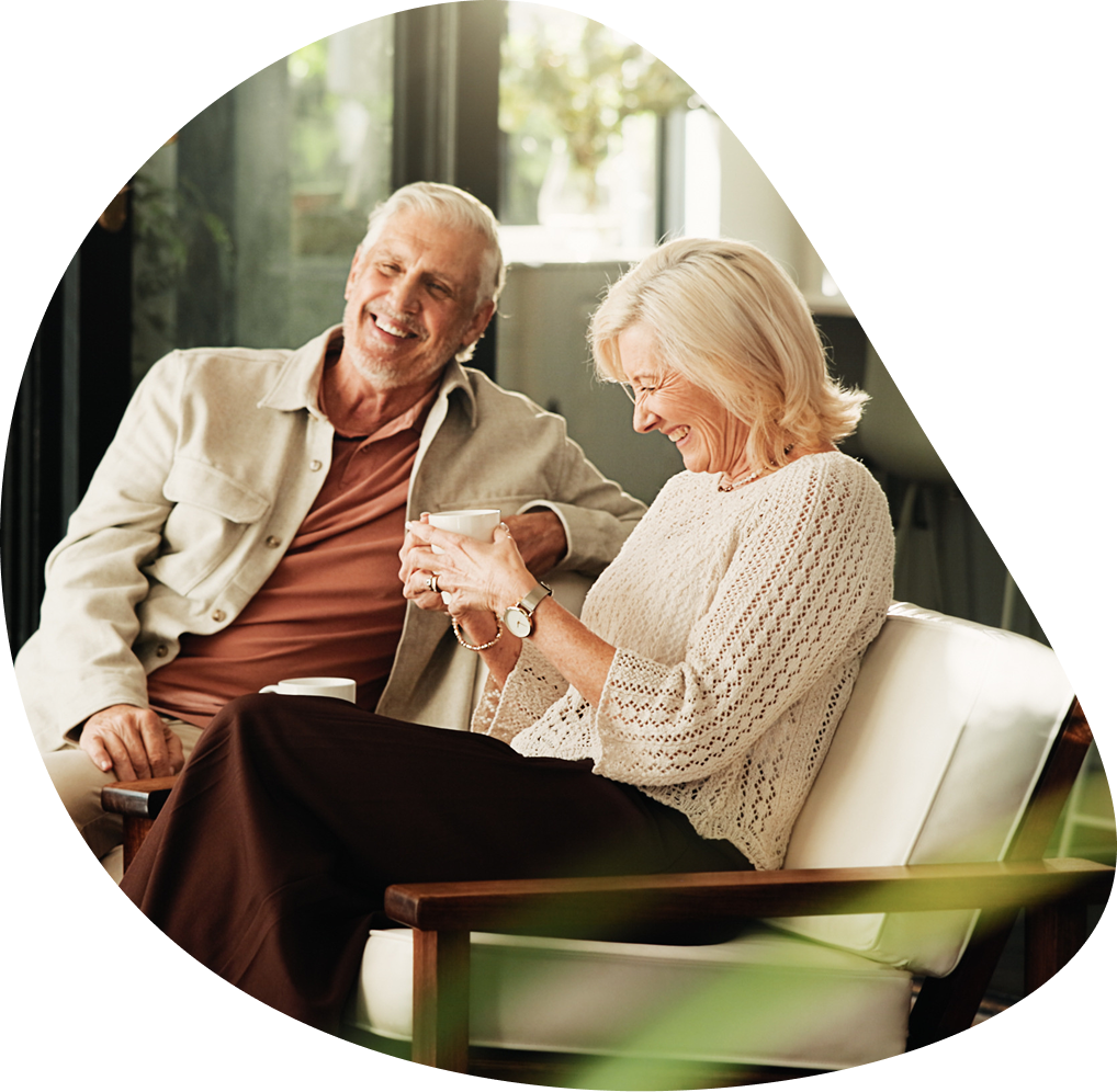Laughing older couple sharing coffee together | Hemmat Law Group