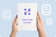 Hands holding a Learning Center card on blue background | Hemmat Law Group