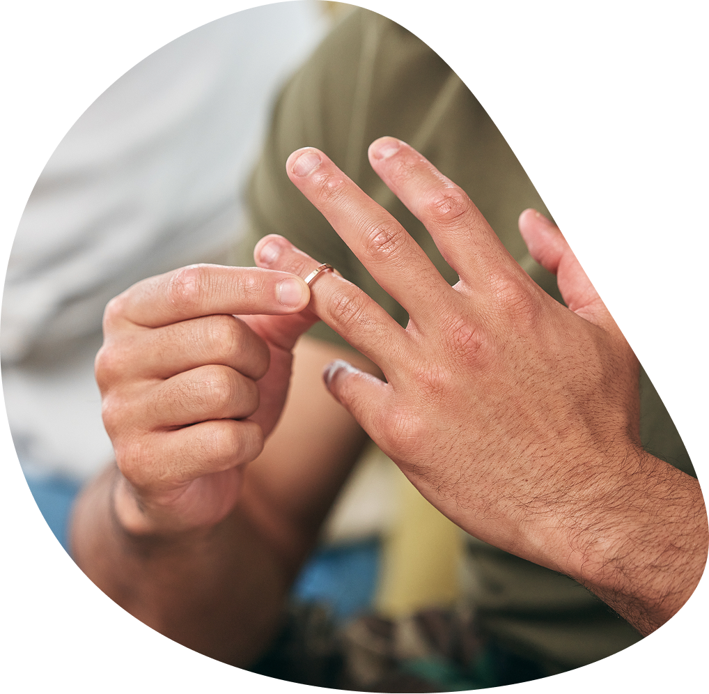 Man sliding off wedding ring | Hemmat Law Group
