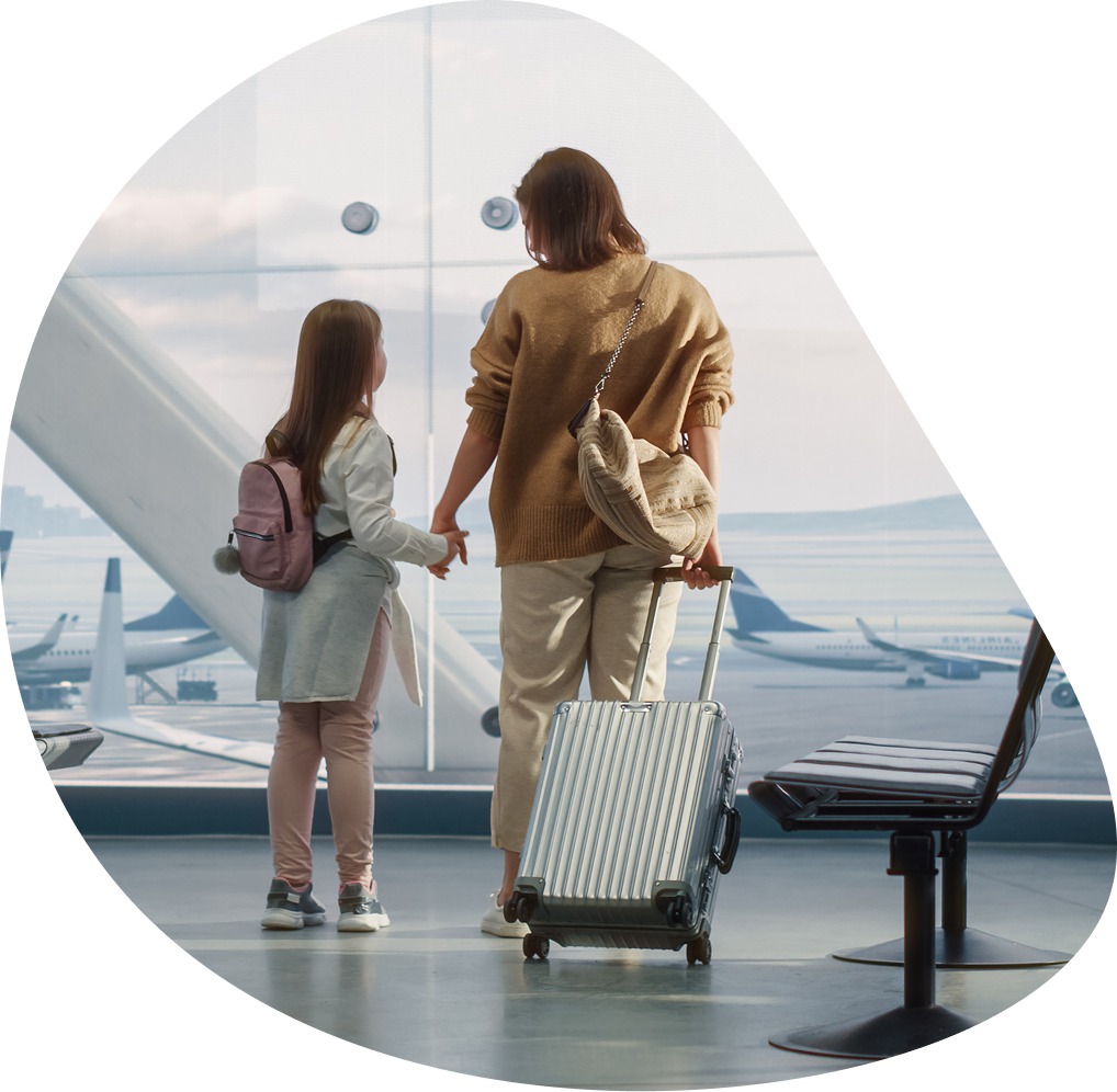 Mother and daughter watching planes at gate | Hemmat Law Group
