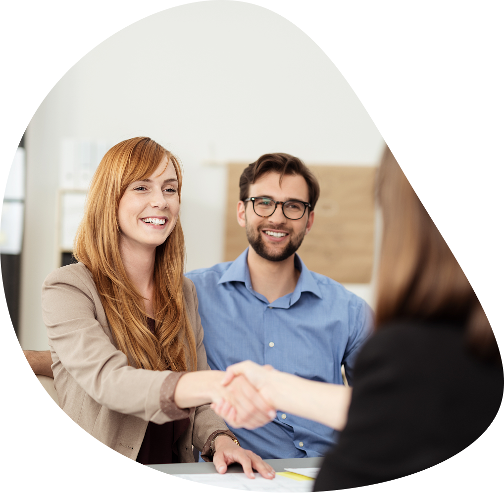 Redhead woman shaking hands with advisor | Hemmat Law Group
