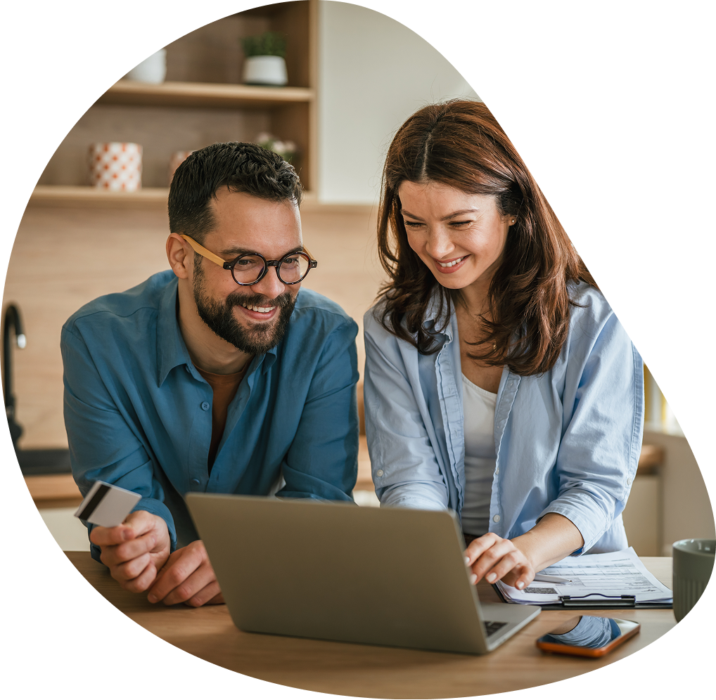 Smiling couple with credit card using laptop | Hemmat Law Group